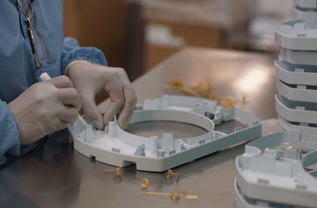 A person is working on a piece of plastic material