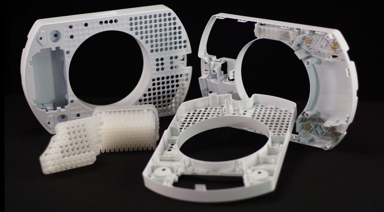 A group of white plastic parts are sitting on top of each other on a table