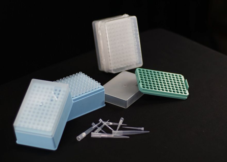 A bunch of plastic containers and pipettes on a table
