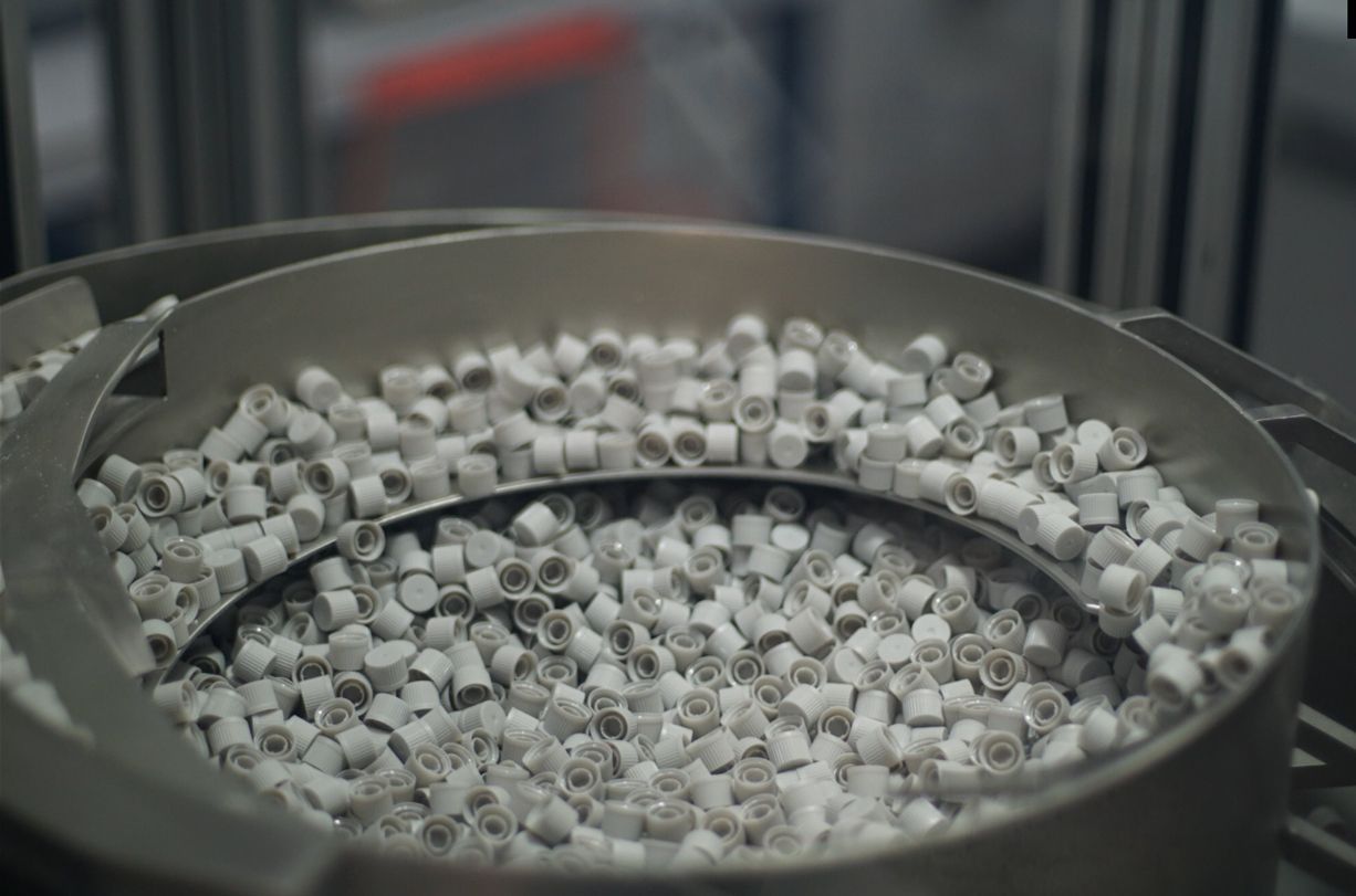 A conveyor belt filled with a lot of small pieces of plastic