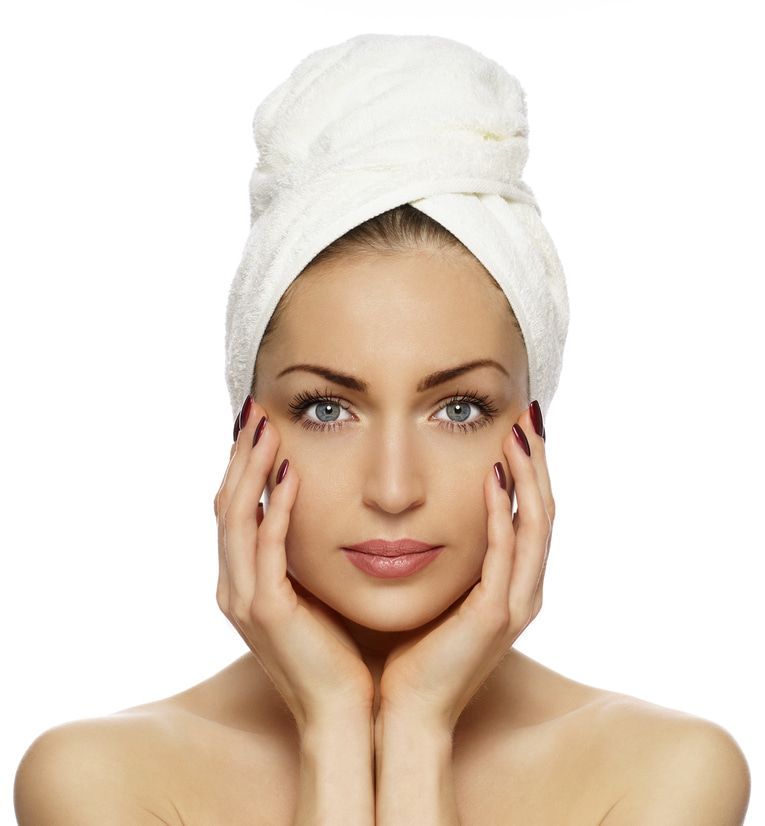 Woman is Looking at Her Acne Prone Face — Advanced Cosmetic & Beauty Clinic in Bundaberg South, QLD