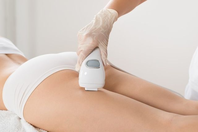 Woman is Getting a Laser Hair Removal Treatment on Her Leg — Advanced Cosmetic & Beauty Clinic in Bundaberg South, QLD