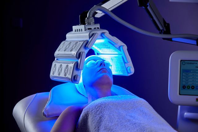 Woman is Getting a Blue Light Treatment on Her Face — Advanced Cosmetic & Beauty Clinic in Bundaberg South, QLD