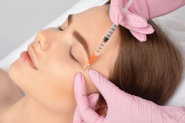 Woman is Getting a Botox Injection in Her Forehead — Advanced Cosmetic & Beauty Clinic in Bundaberg South, QLD