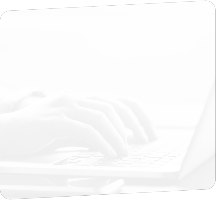 Hands typing on a laptop keyboard.