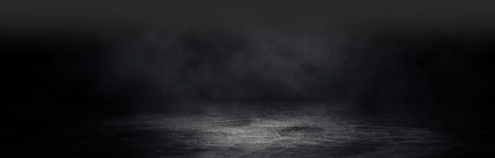 A dark, atmospheric scene. A reflective surface under a hazy, smokey backdrop.