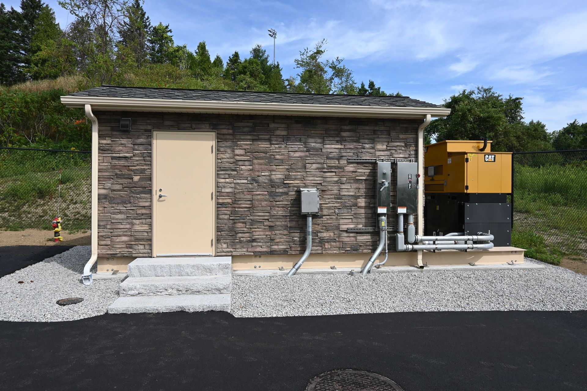 A small brick building with a yellow door