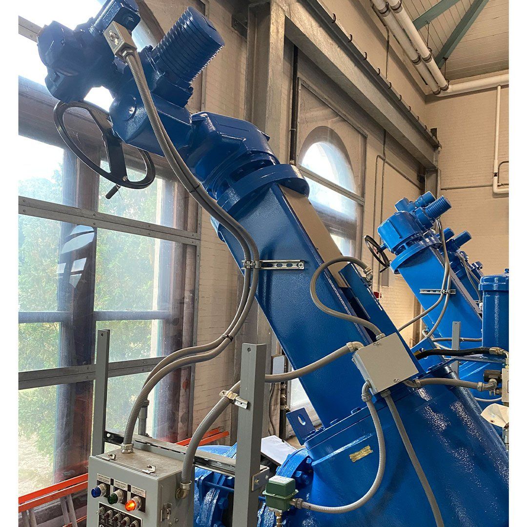 A large blue machine is sitting in a room next to a window