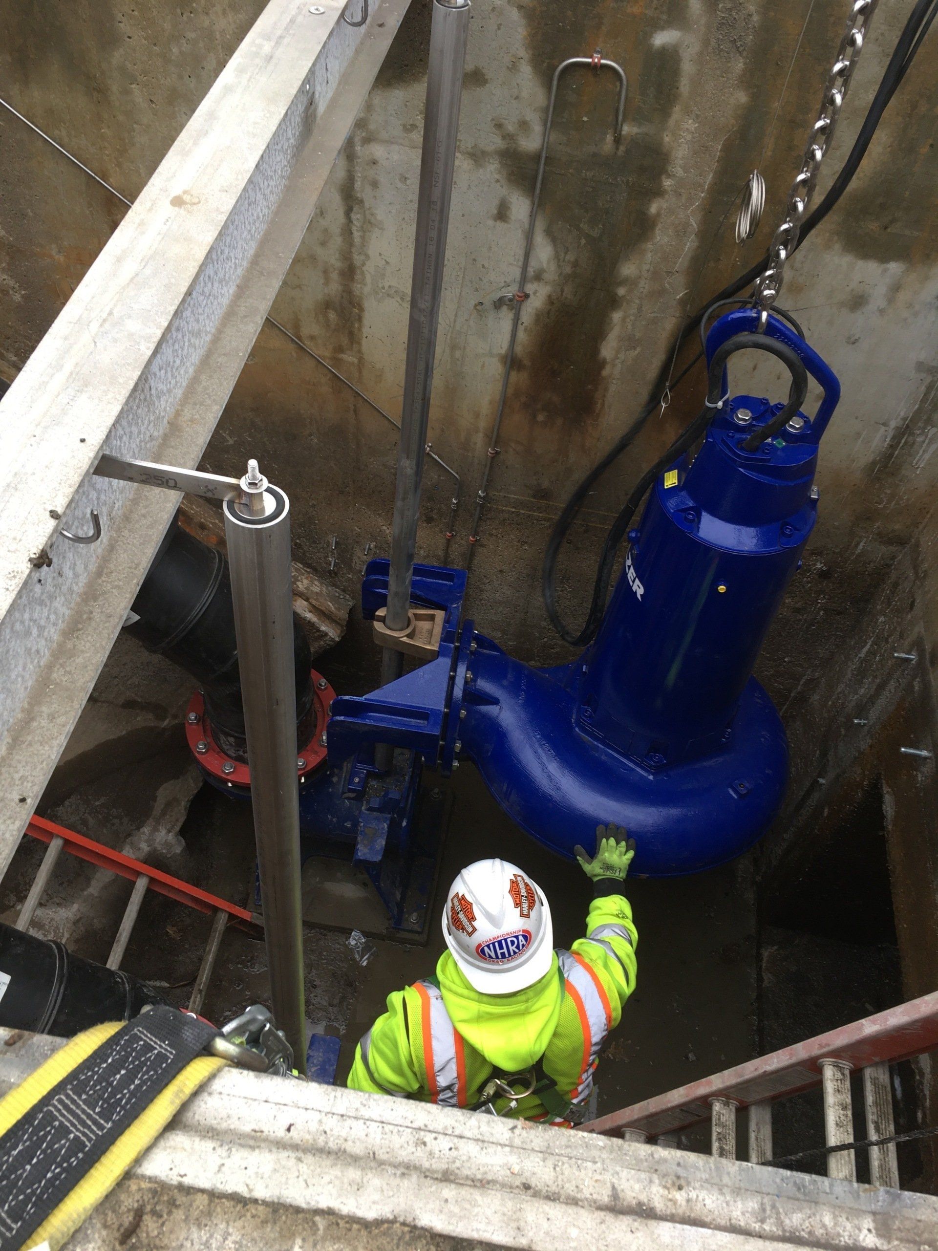 A man is working on a pump in a tunnel.