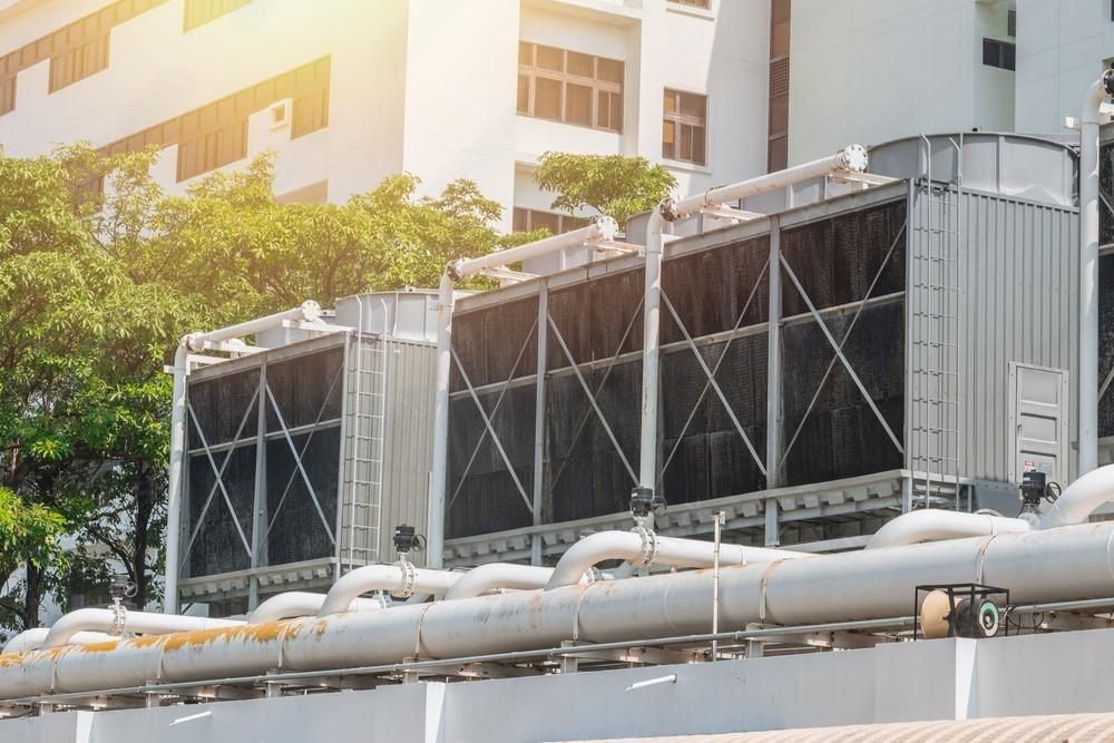 A large building with a lot of pipes coming out of it.