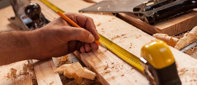 Canbinetmaker taking measurements