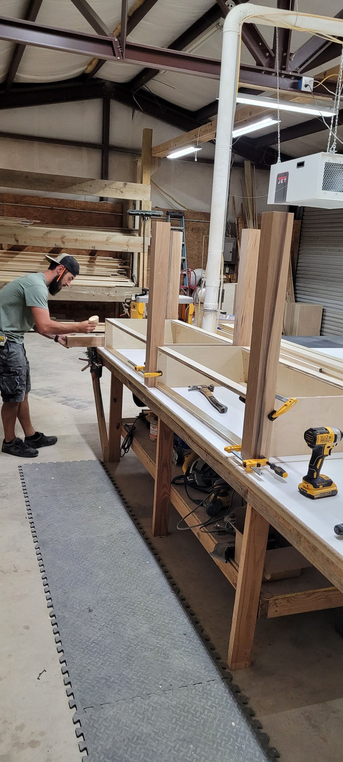 A man is working on a piece of wood in a factory.