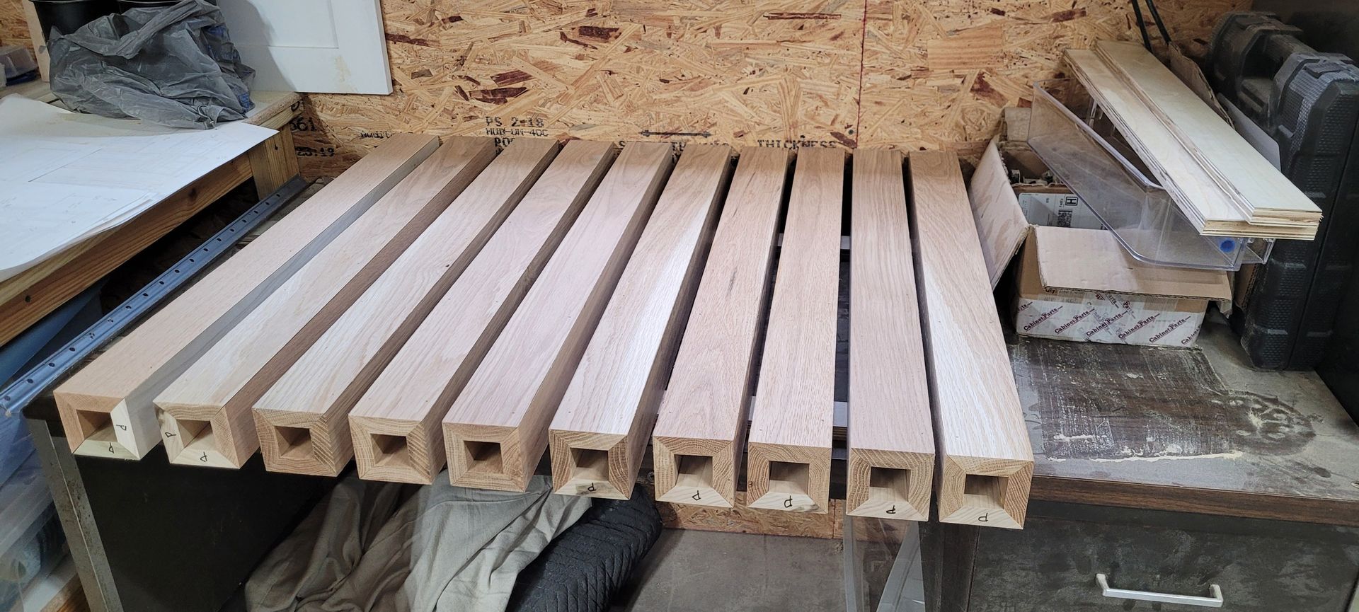 A bunch of wooden boards are stacked on top of each other on a table.