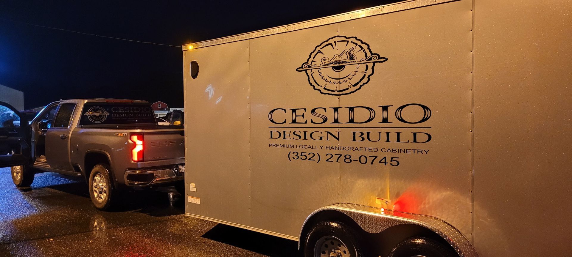 A truck is parked next to a trailer that says cesidio design build.