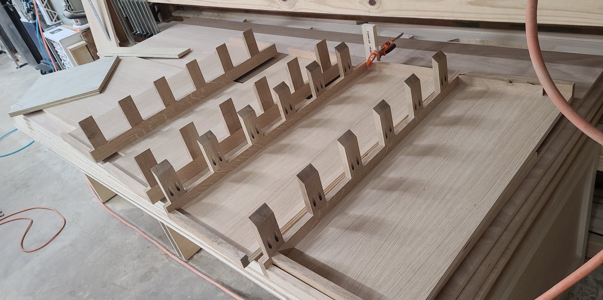 A bunch of wooden pieces are sitting on top of a wooden table.