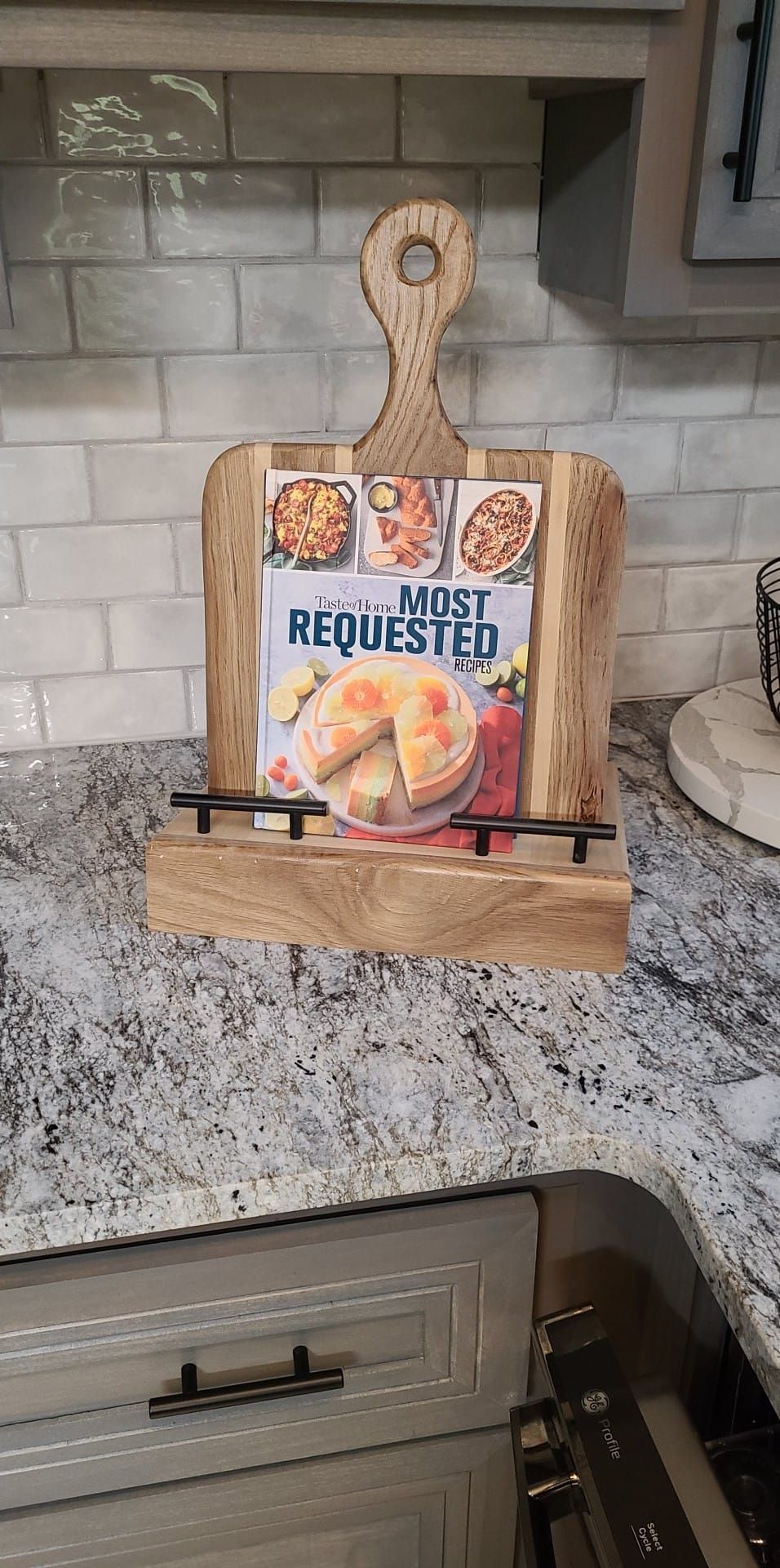 A wooden cutting board is sitting on top of a kitchen counter.