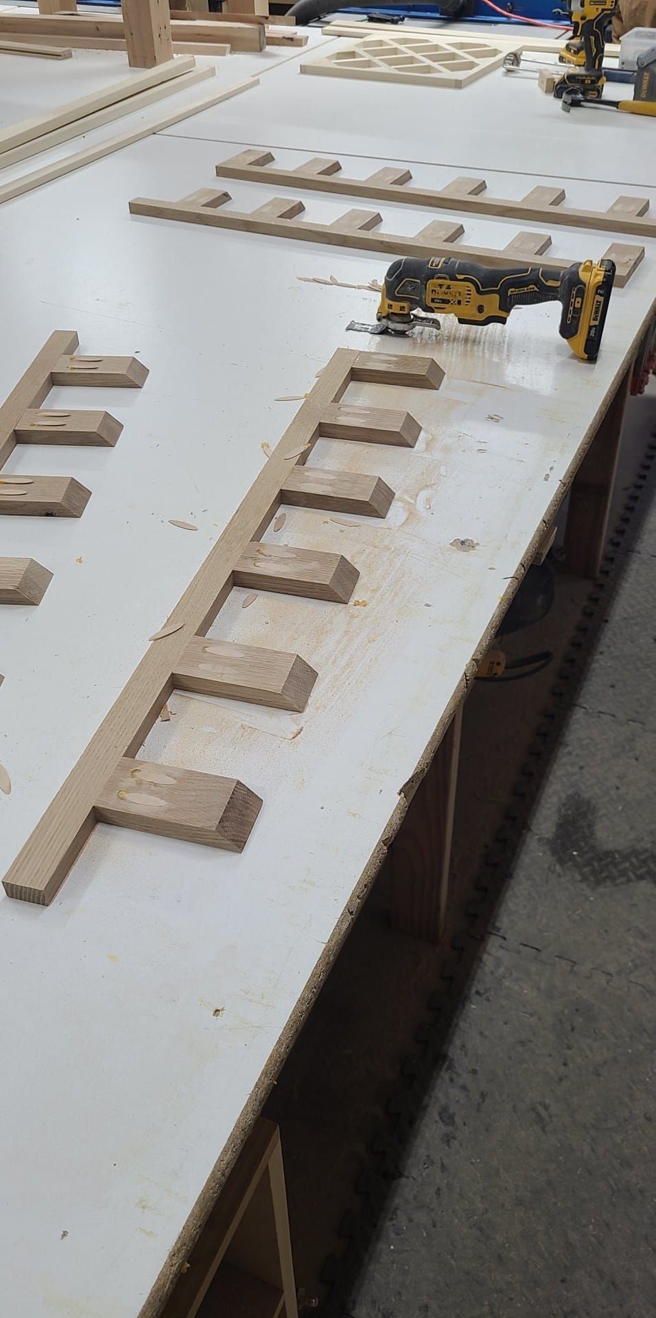 A drill is sitting on top of a wooden table.