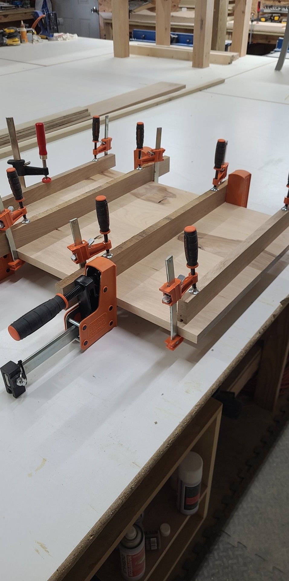 A couple of clamps sitting on top of a wooden table.