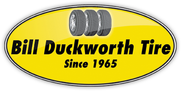 Yellow oval logo featuring three tire icons above the text "Bill Duckworth Tire" and "Since 1965".