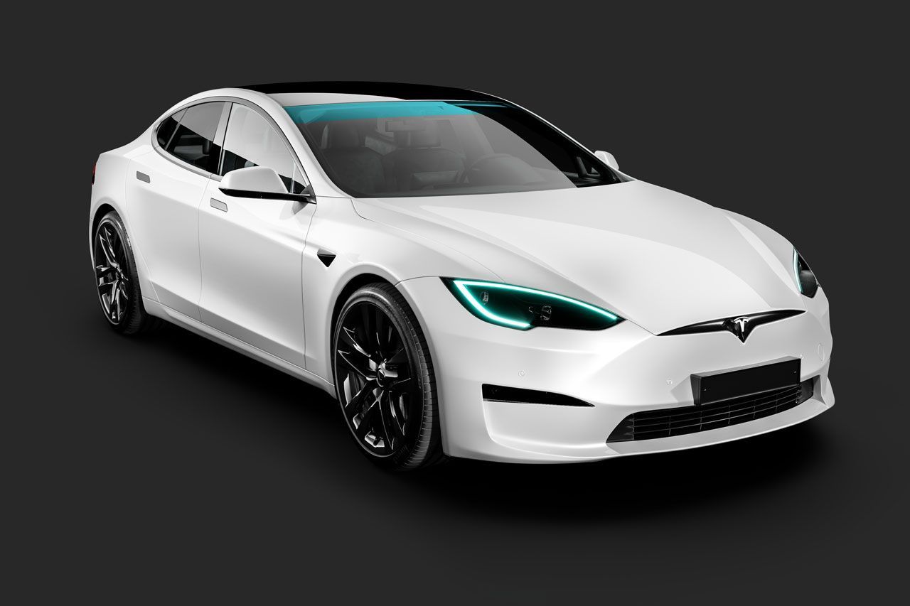 A white tesla model s with green lights on a black background.