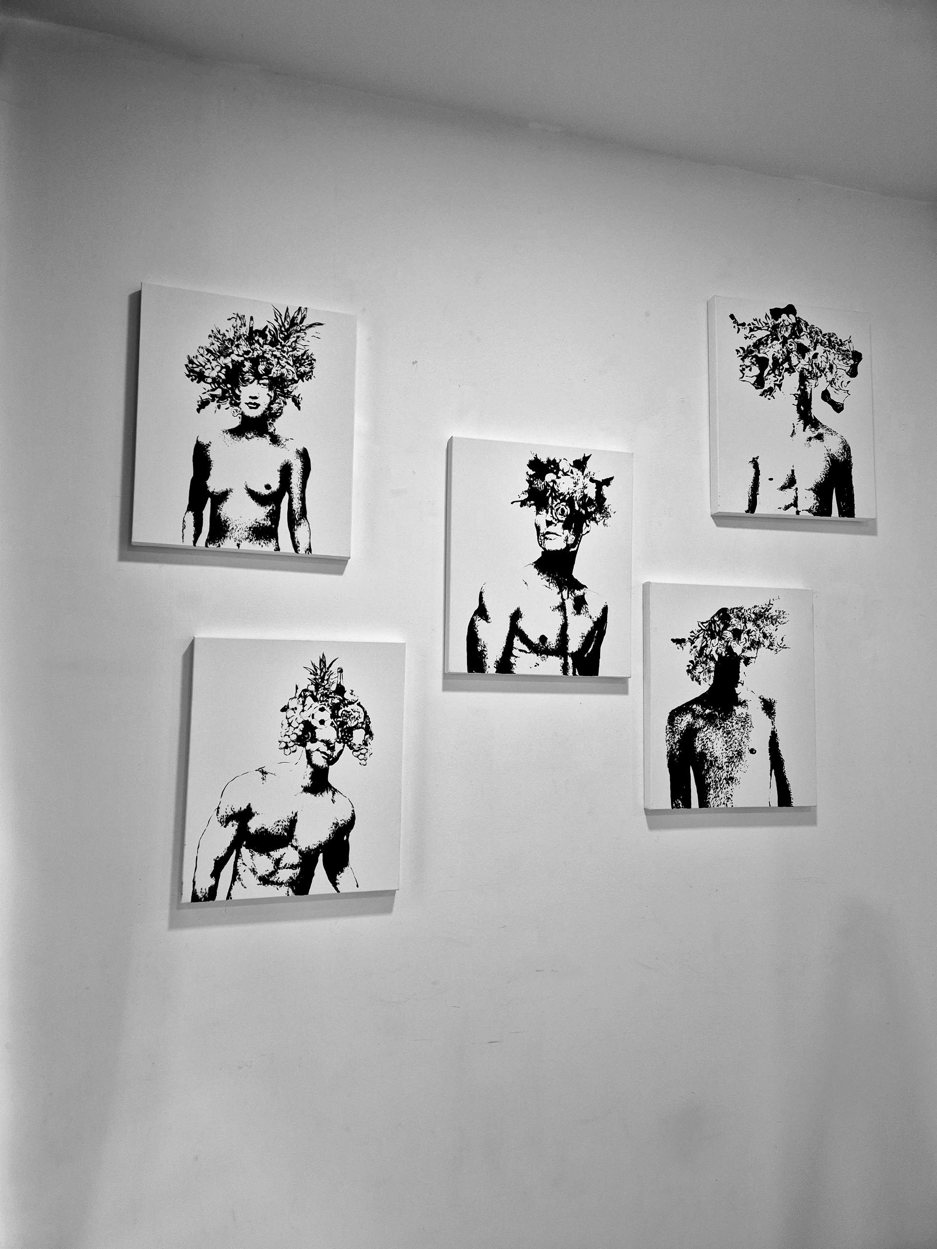 Five black and white paintings on a white wall. Each depicts a person with a floral head.