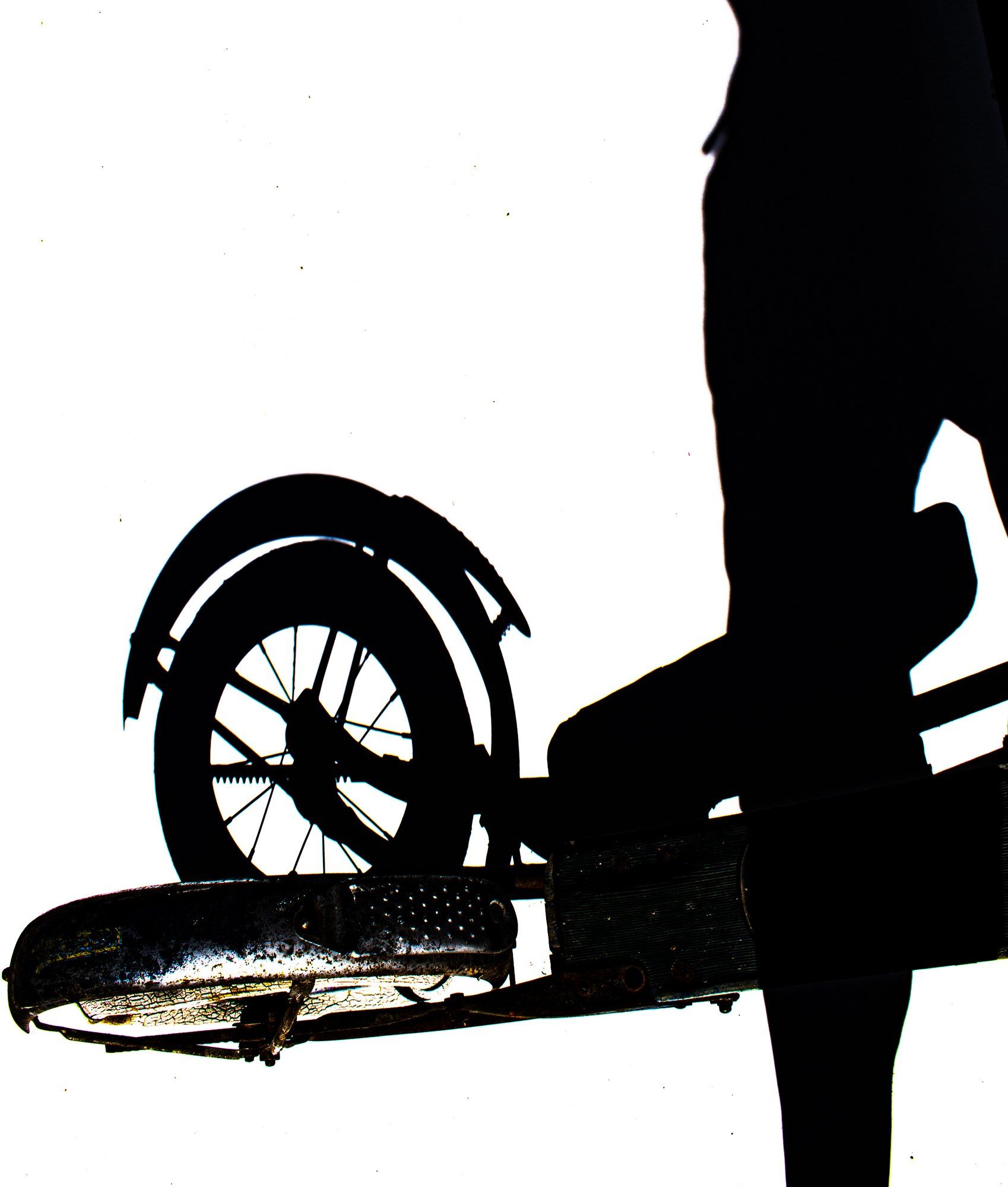 a silhouette of a person standing next to a byke