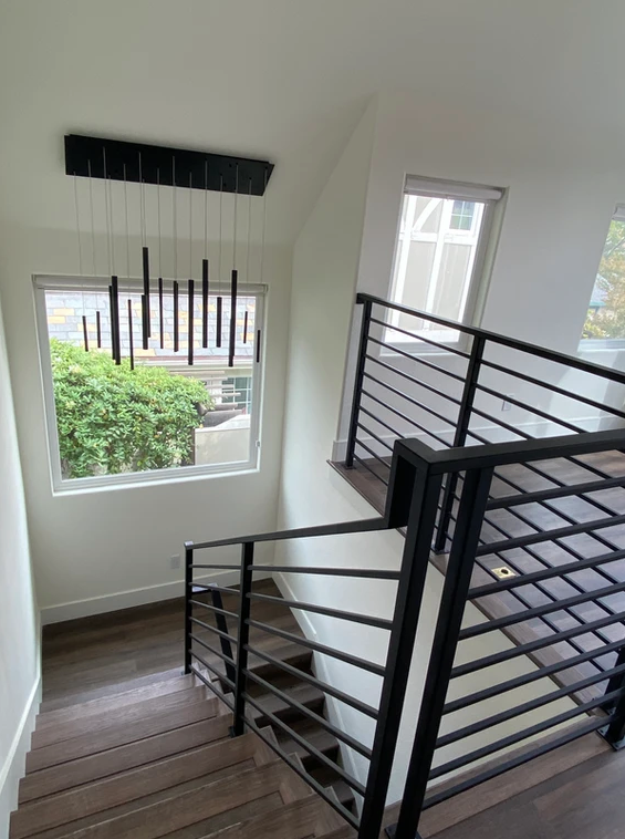 A staircase with a railing and a window in a house.