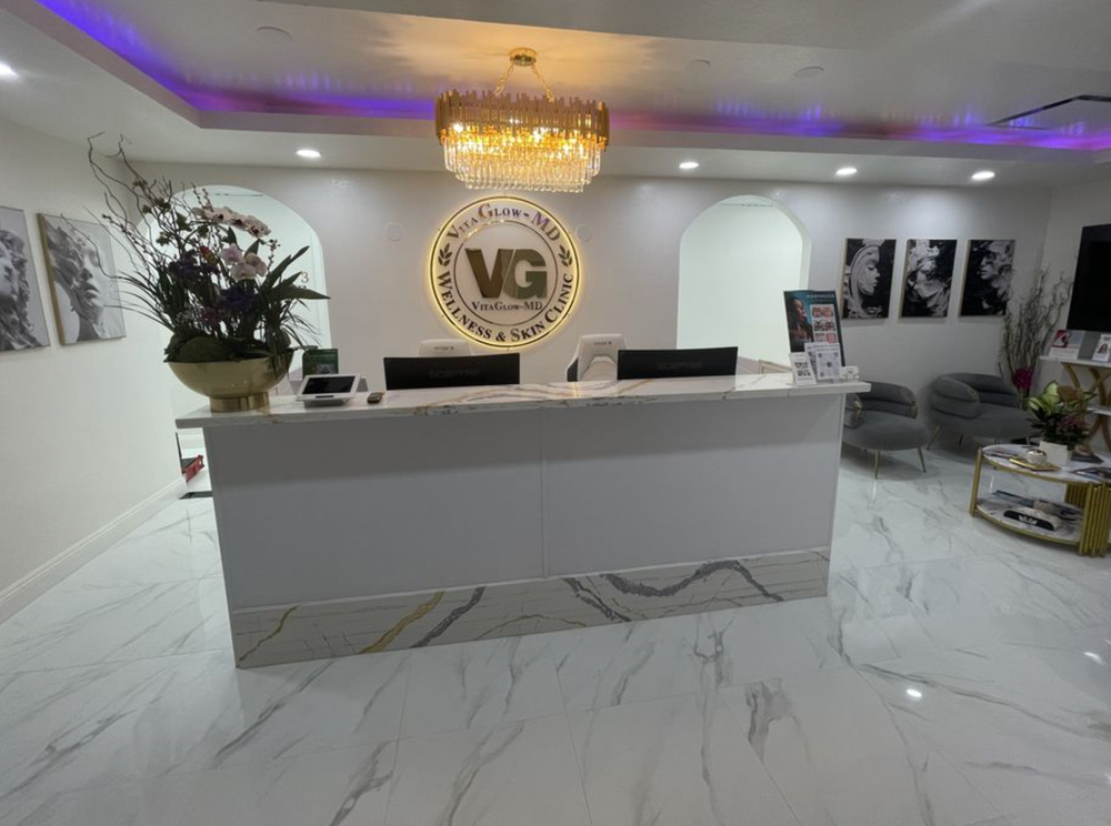 A reception area with a vg logo on the wall