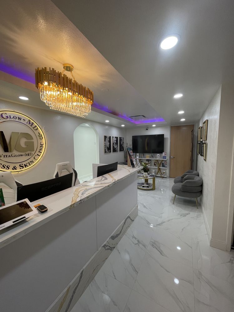 There is a chandelier hanging from the ceiling above the reception desk.