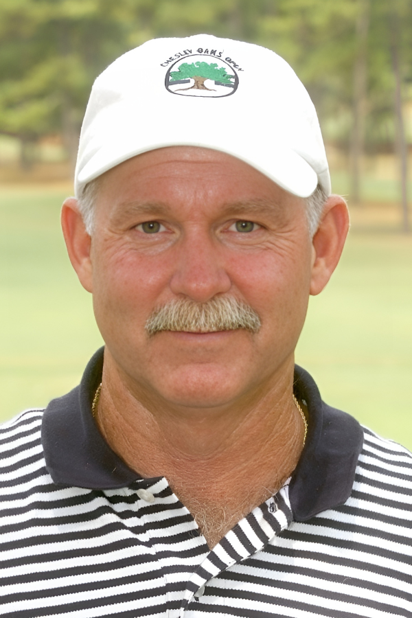 A man wearing a white hat with a tree on it