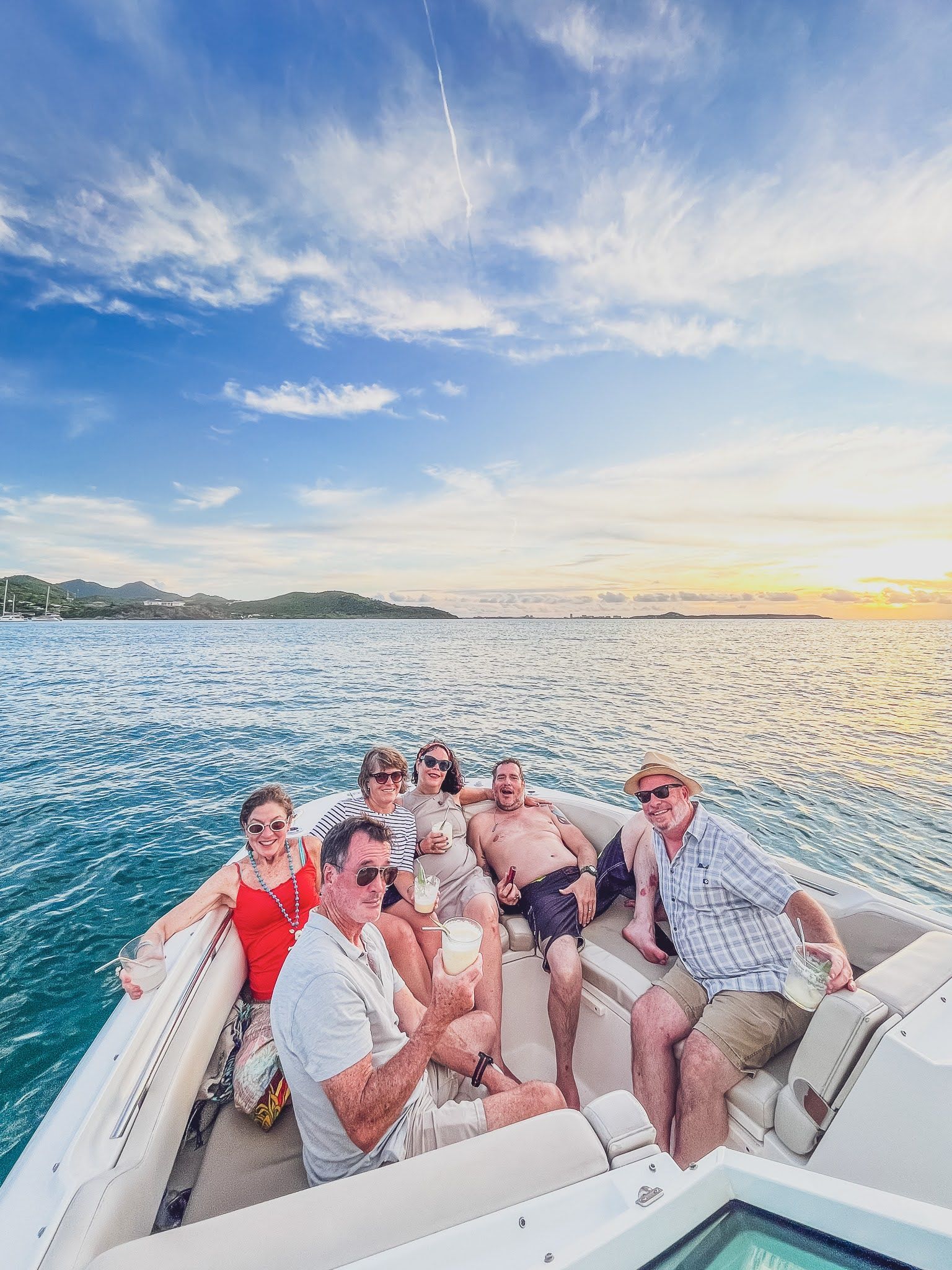 A group of people are sitting on a boat in the water.
