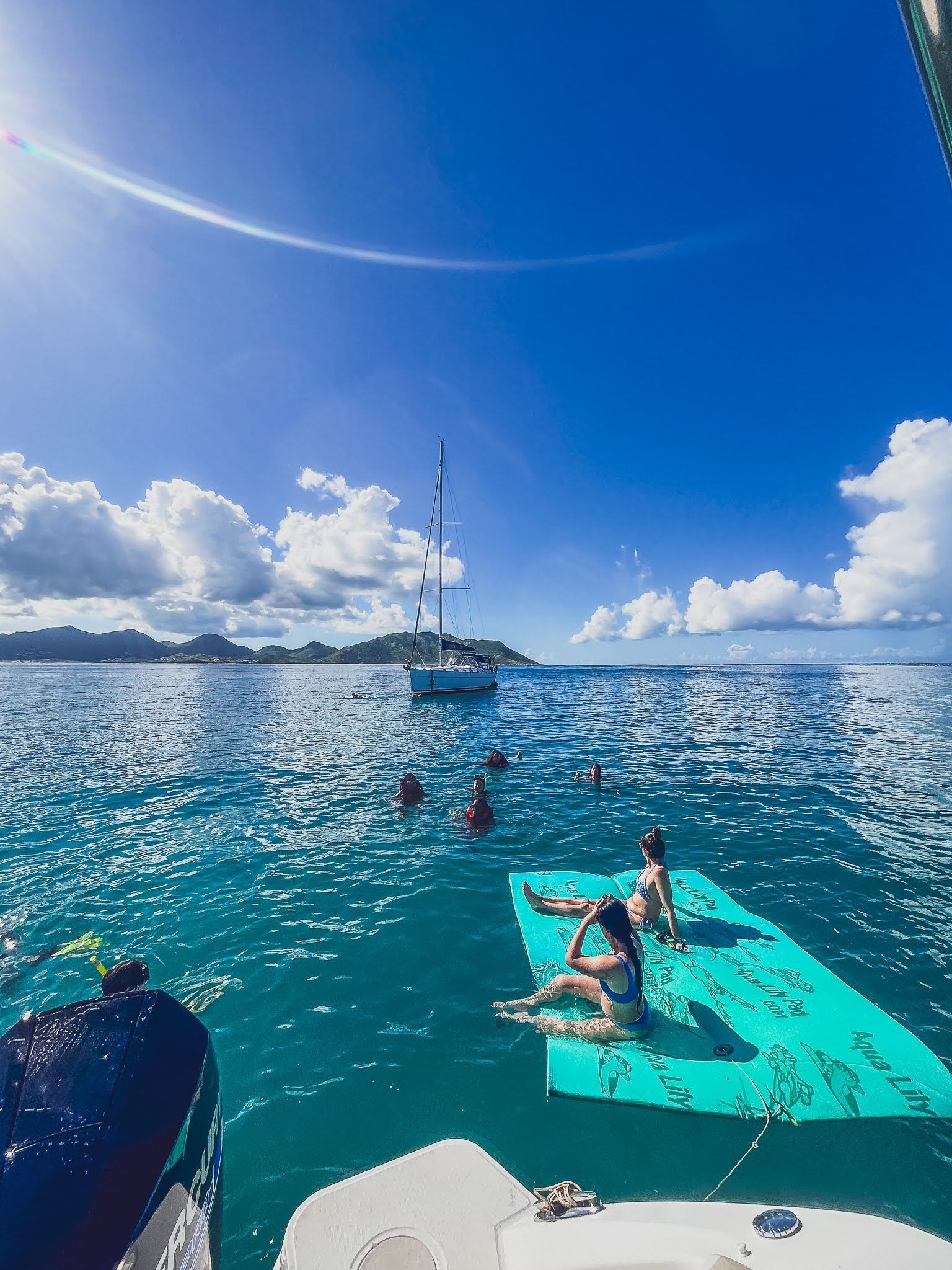 A group of people are floating on a raft in the ocean.