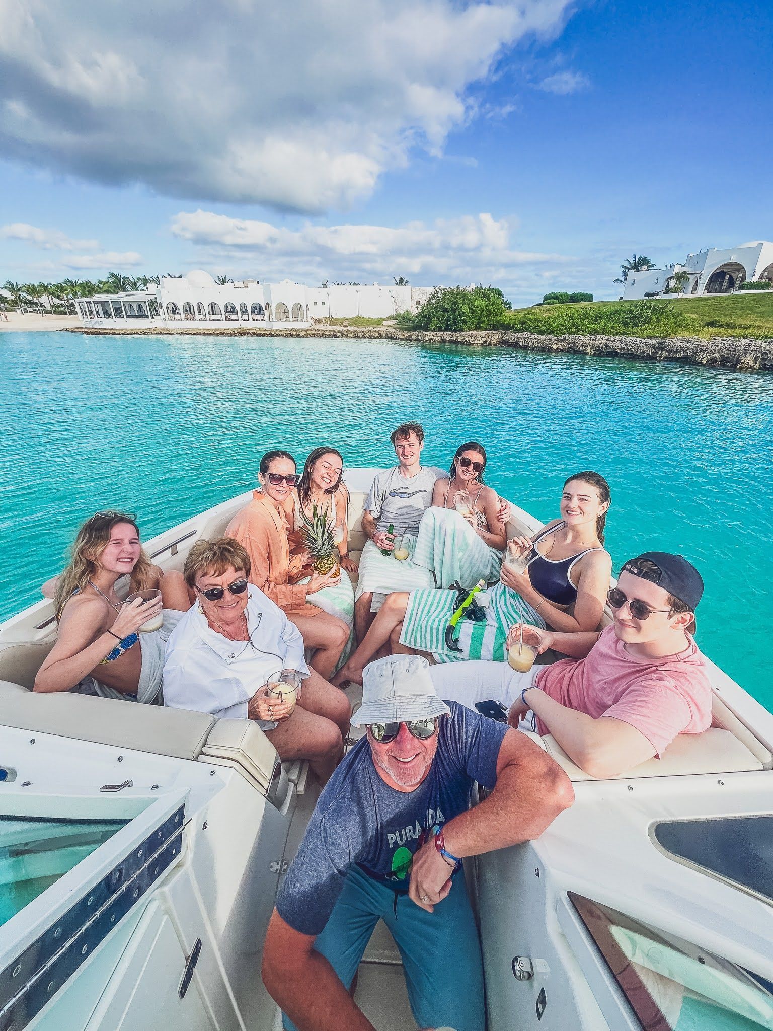 A group of people are sitting on a boat in the ocean.