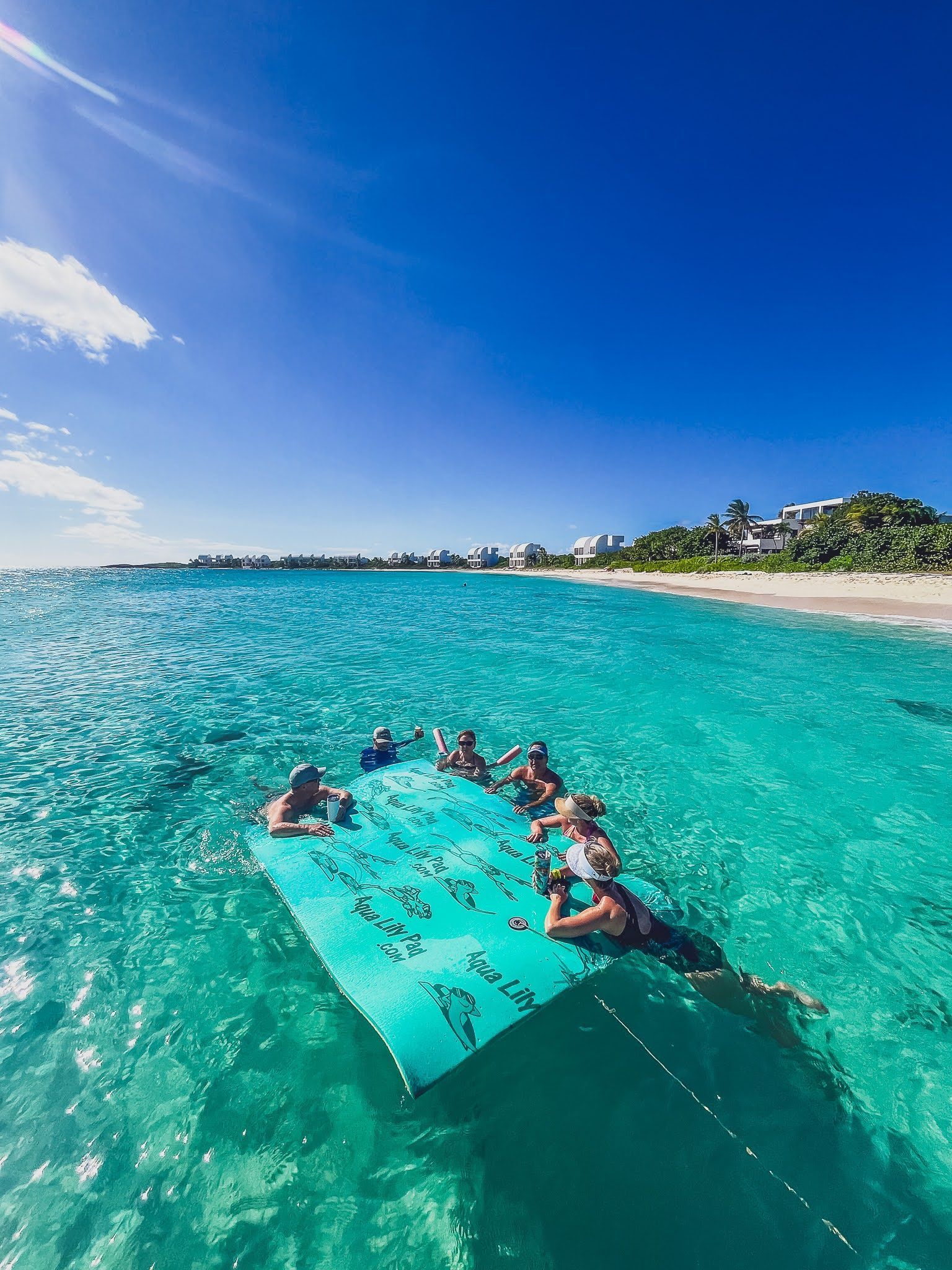 A group of people are floating on a raft in the ocean.