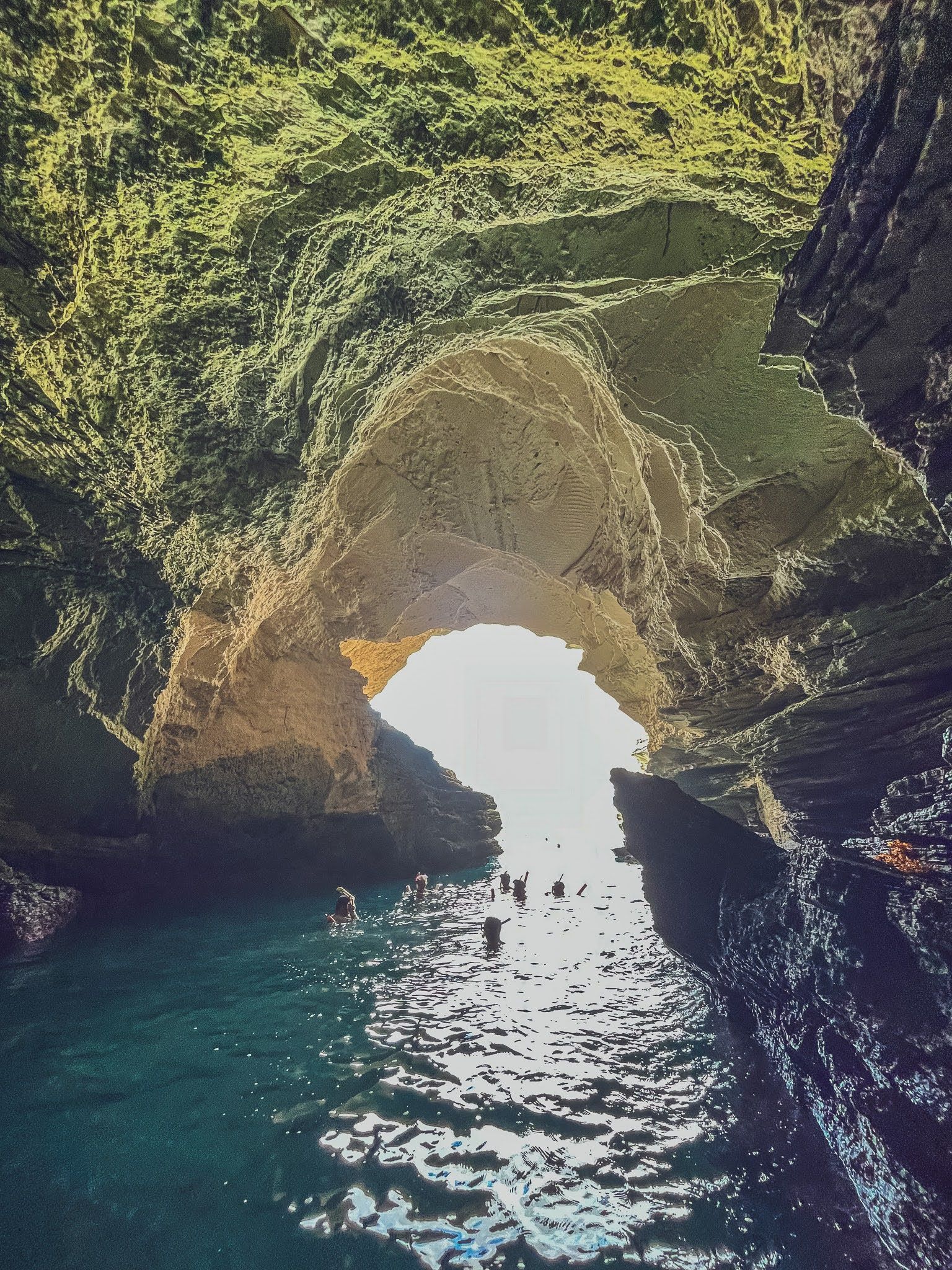 A cave filled with water and a light coming out of it