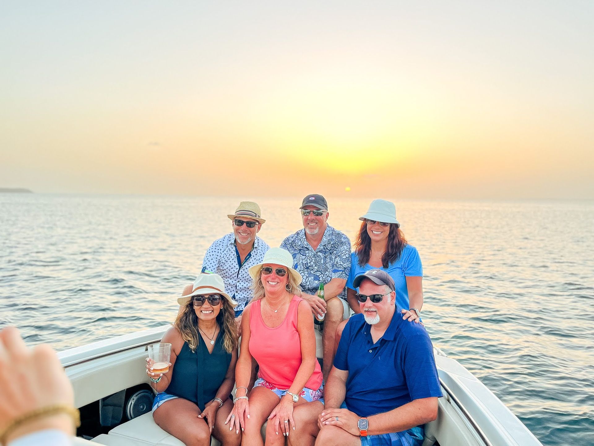 A group of people are sitting on a boat in the ocean.