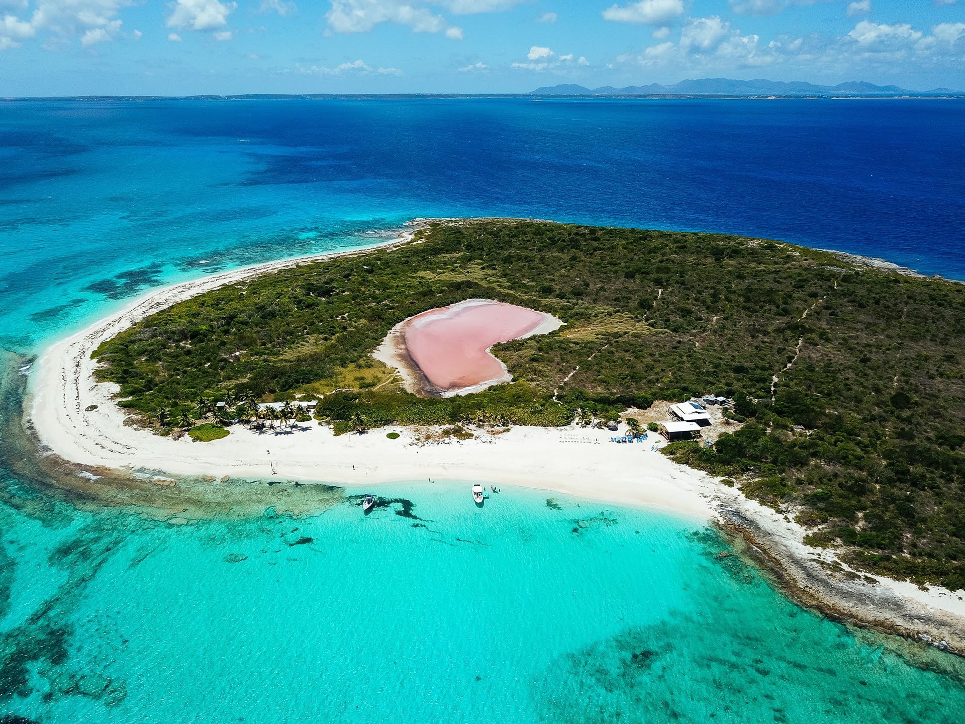 An aerial view of a small island in the middle of the ocean.