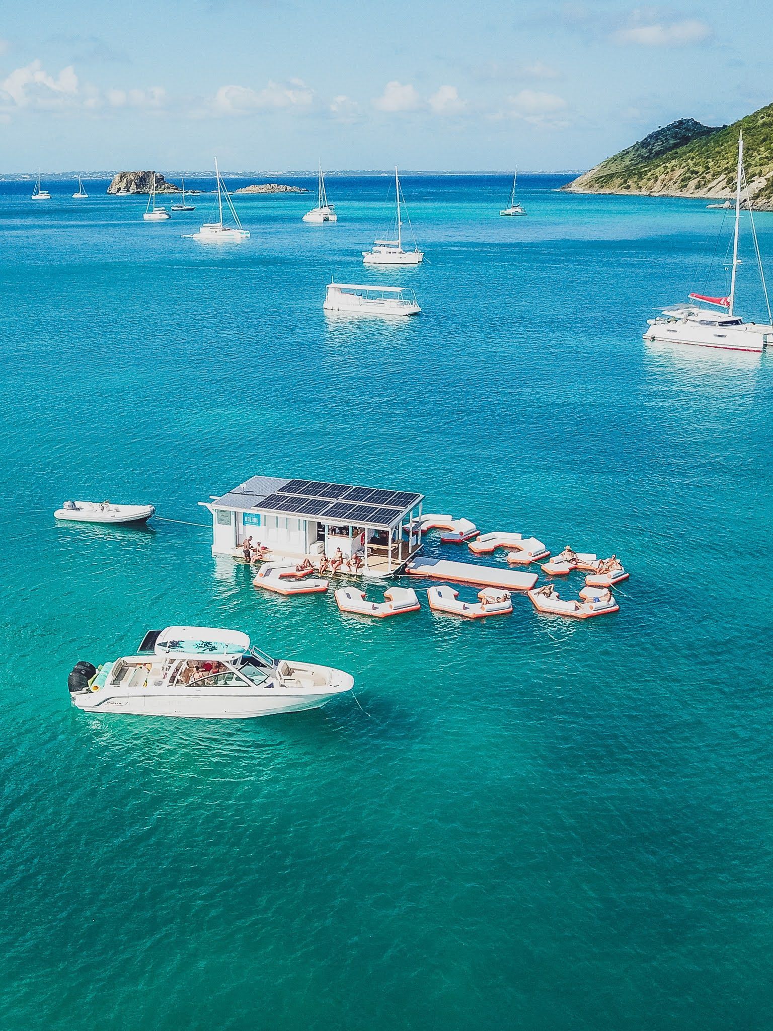 A group of boats are floating on top of a body of water.