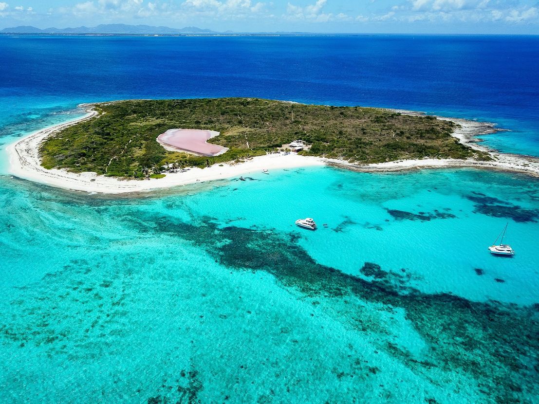 An aerial view of a small island in the middle of the ocean.