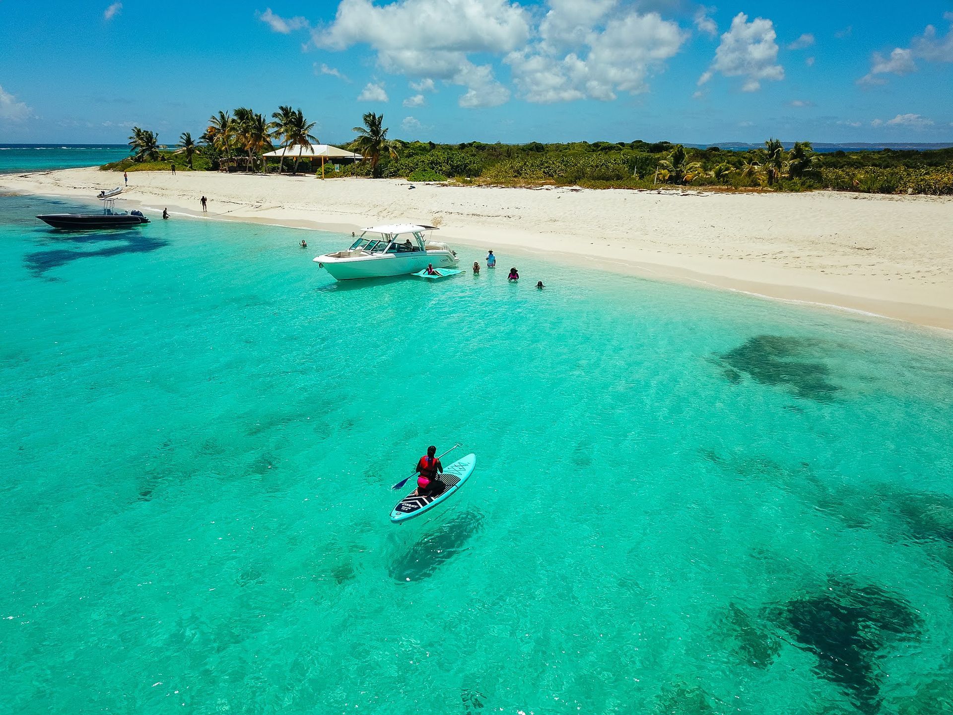 An aerial view of a person in a kayak in the ocean.