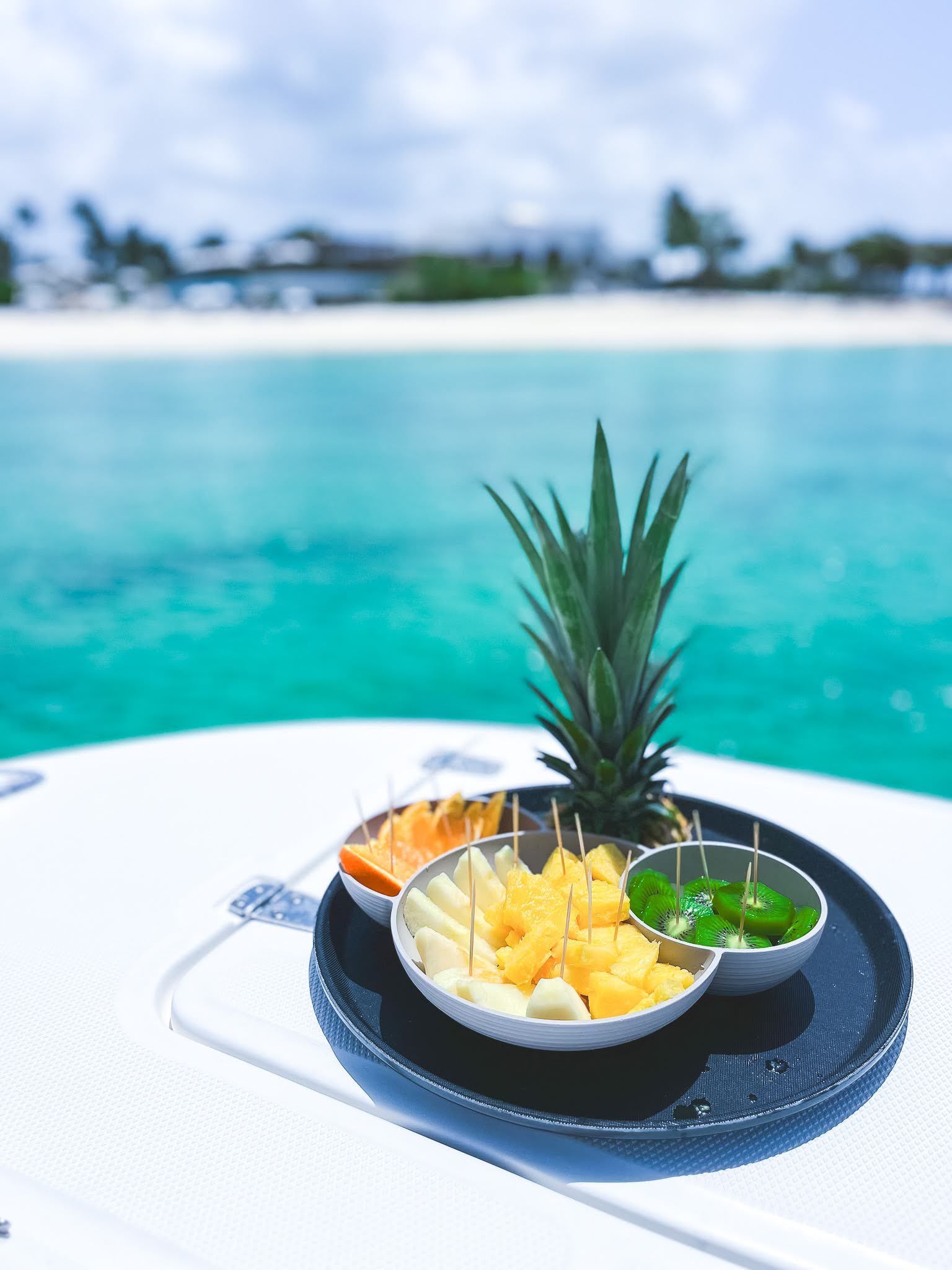 A plate of fruit with a pineapple on top of it
