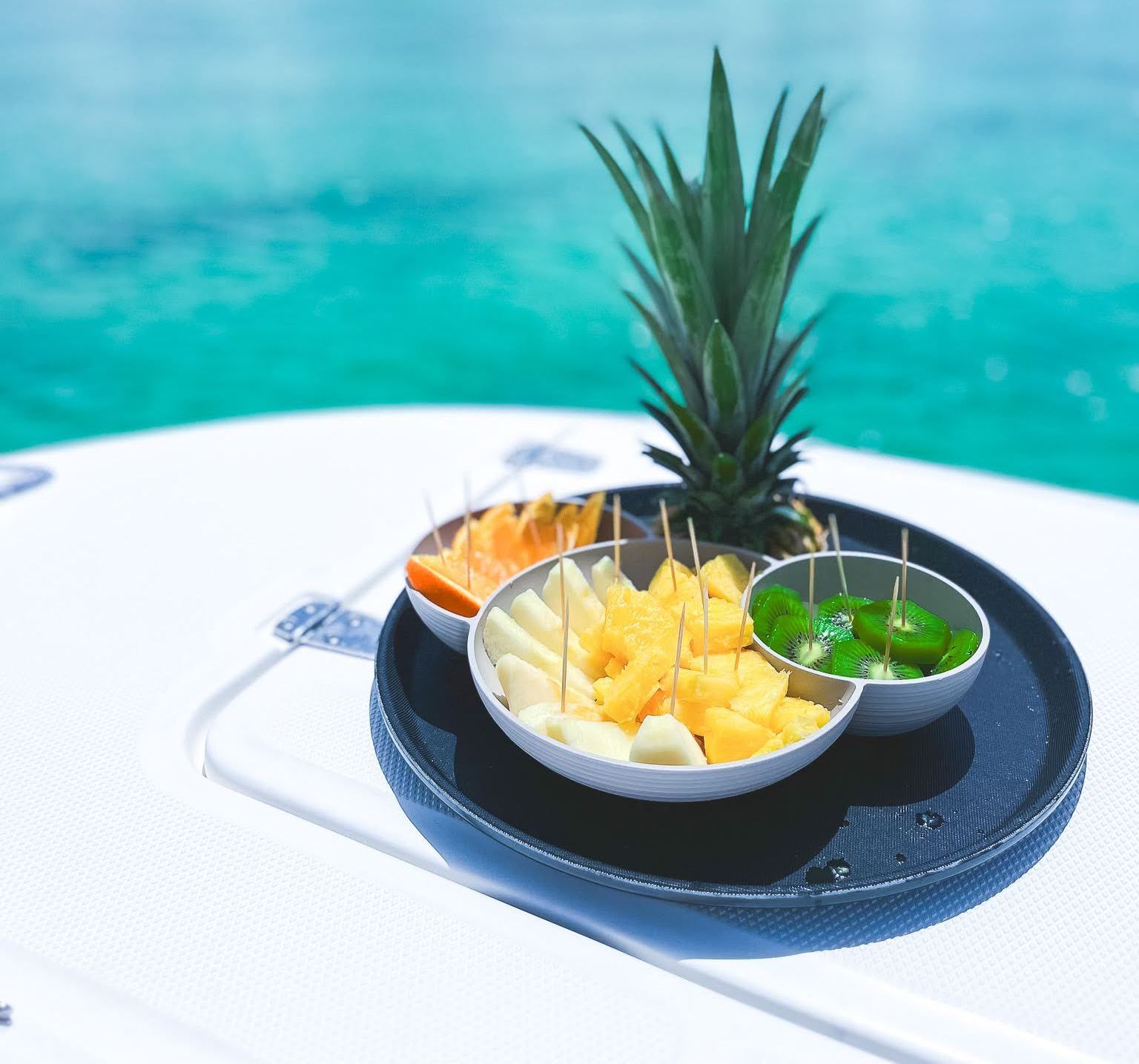 A bowl of fruit with a pineapple on top of it
