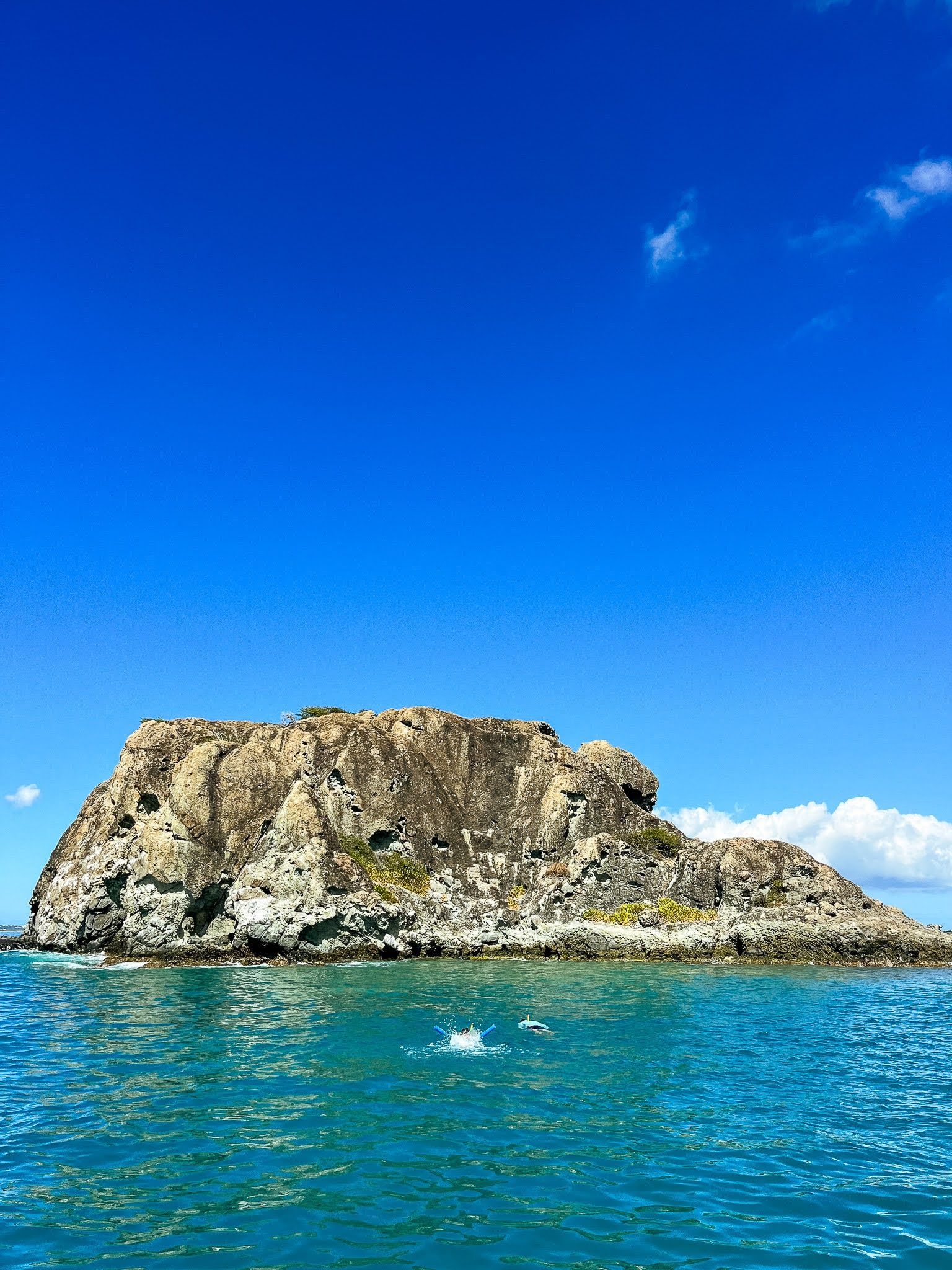 There is a small island in the middle of the ocean.
