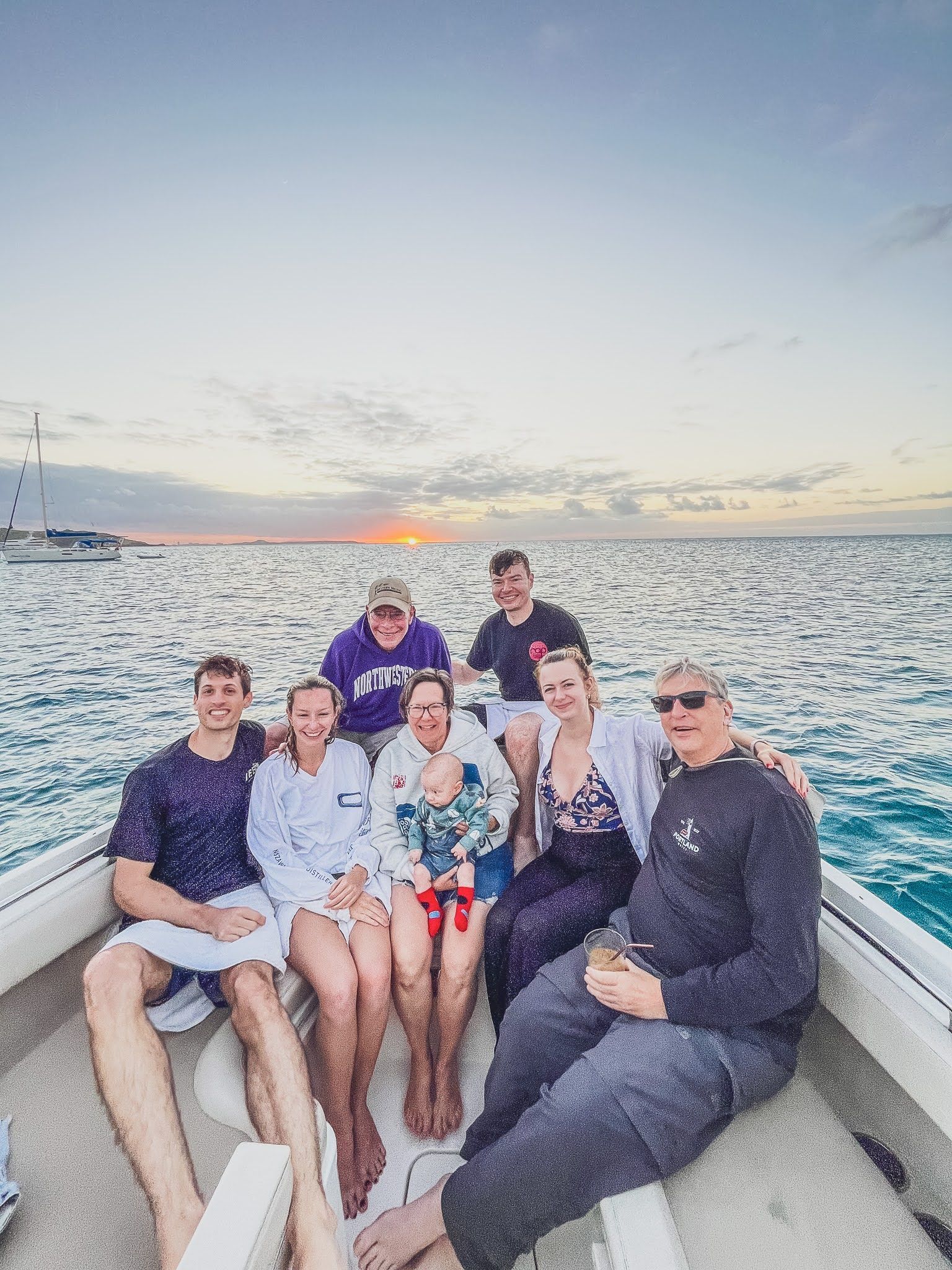 A group of people are sitting on a boat in the ocean.
