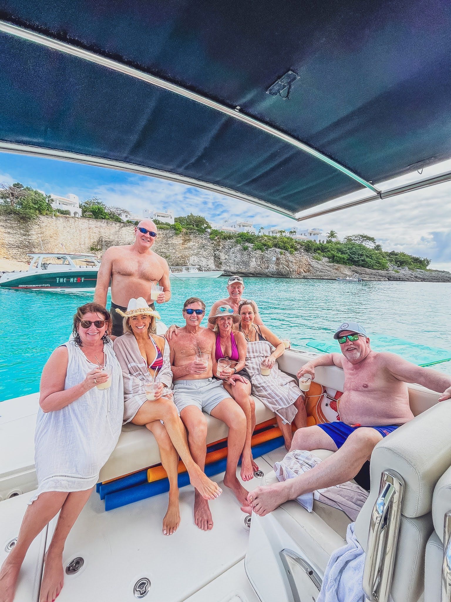 A group of people are sitting on a boat in the water.