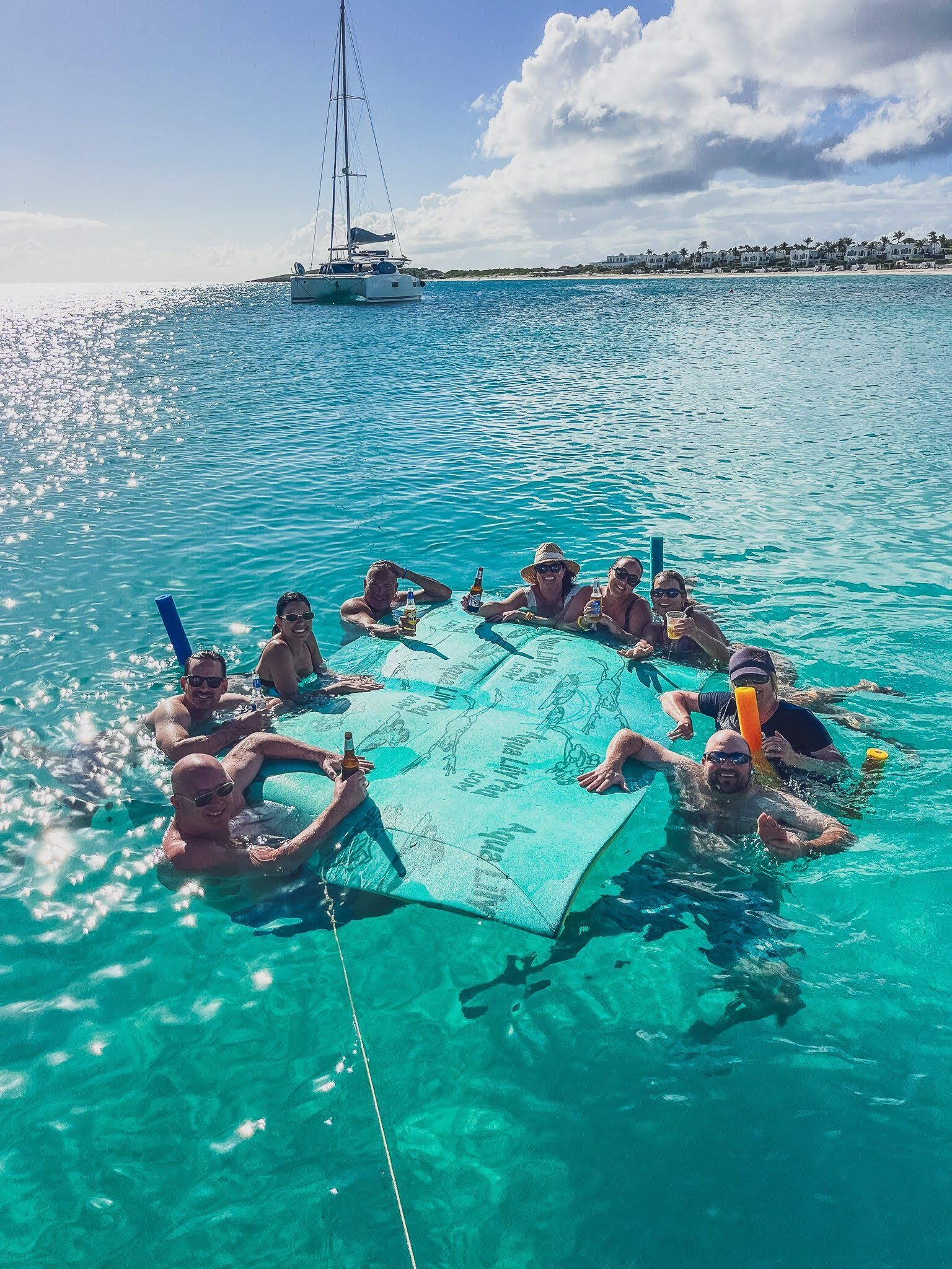 A group of people are floating on a raft in the ocean.