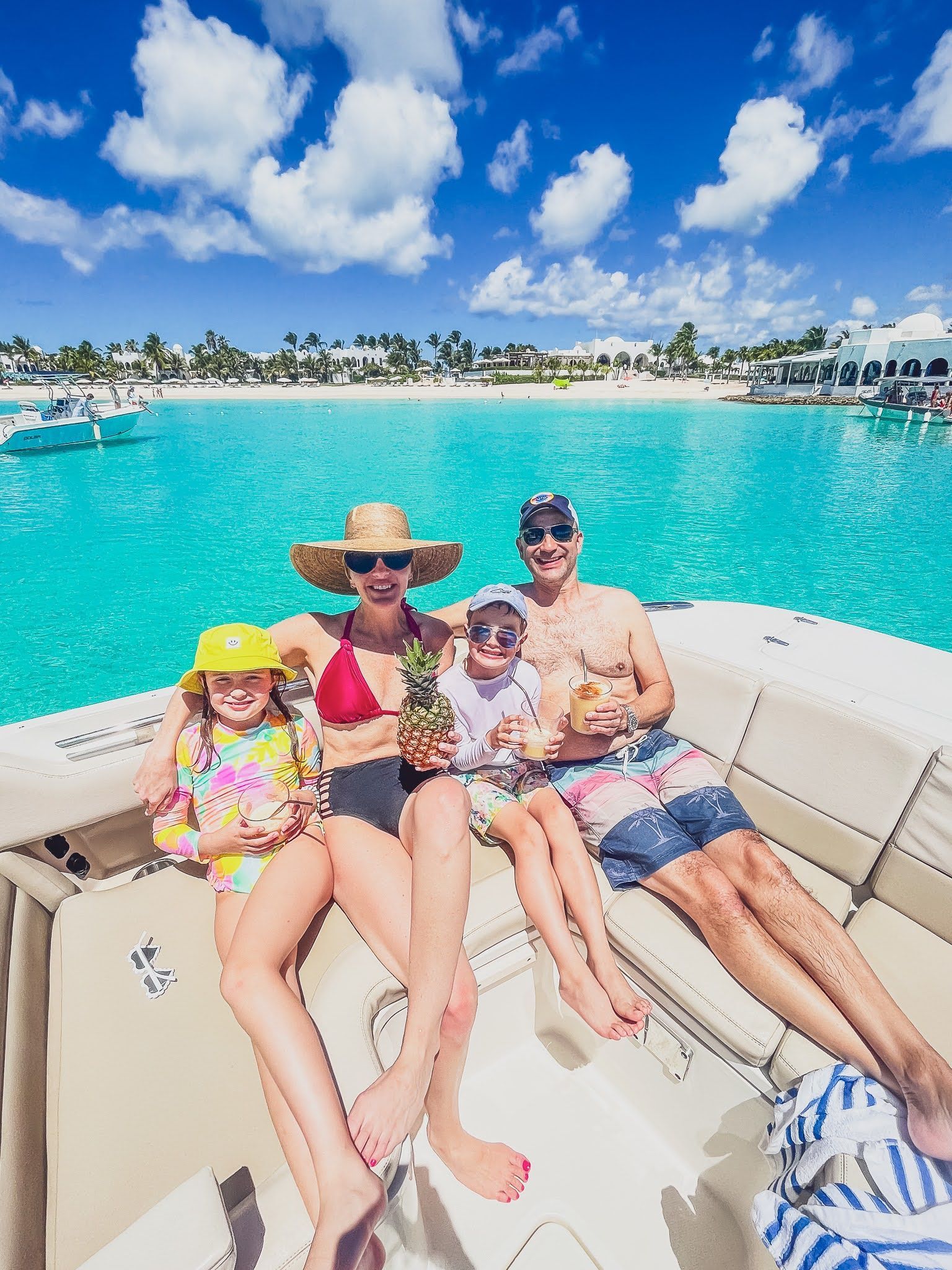 A family is sitting on a boat in the ocean.