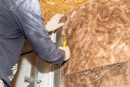 A man installing insulation into an attic in a westminster CO home.