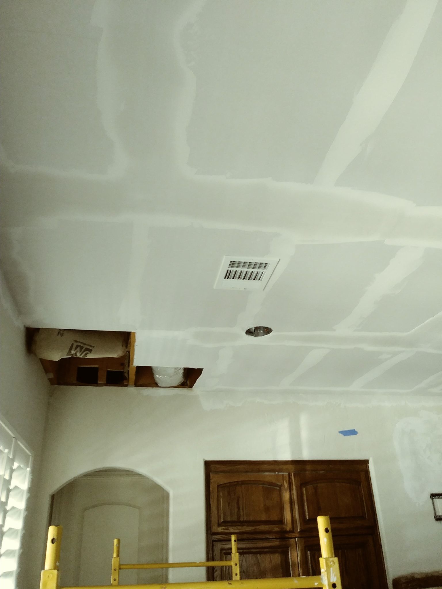 a living room with a scaffolding and a ceiling that is being remodeled .