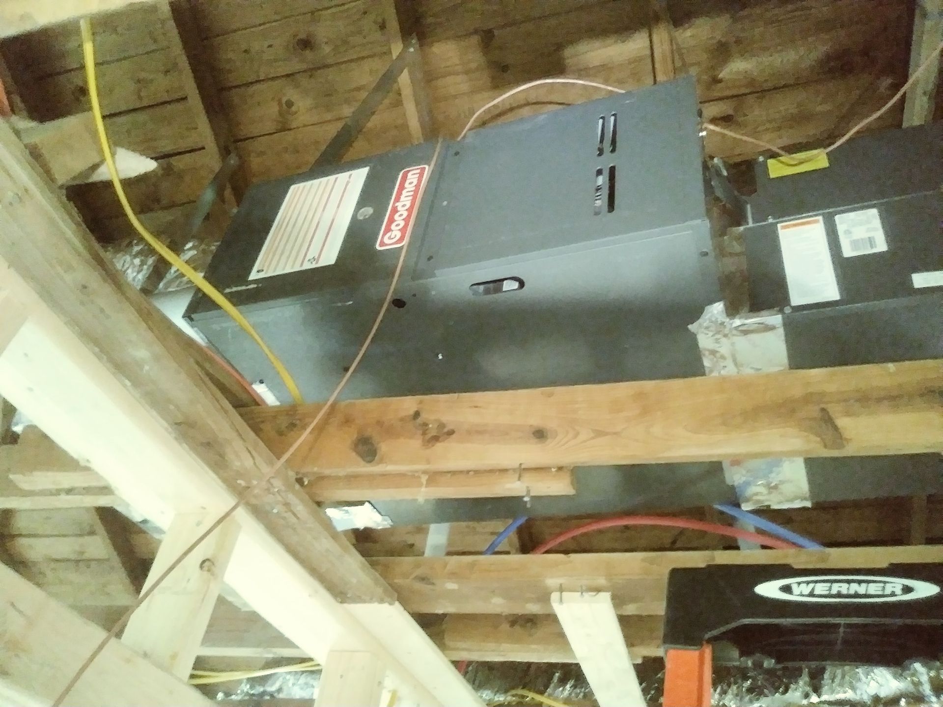 a black box with a warning label on it is hanging from the ceiling